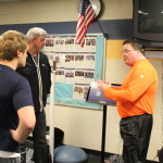 Mike Newvine, right, and Tom Nicklin, left, explain how to use the Fast Pad to Anthony Reiner. Photo by Wendi Reardon