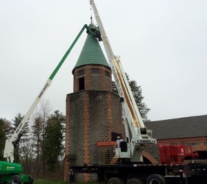 Construction crews hang the bell in the Brady Lodge tower. 