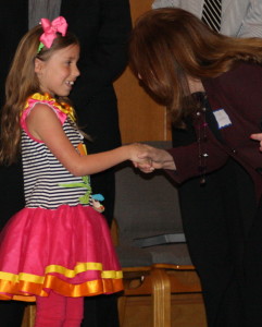 Youth Honor: Alana Brown shakes hands with Clarkston School Board Secretary Susan Boatman at Clarkston Area Youth Assistance annual youth recognition assembly at Clarkston United Methodist Church. Photo by Trevor Keiser 