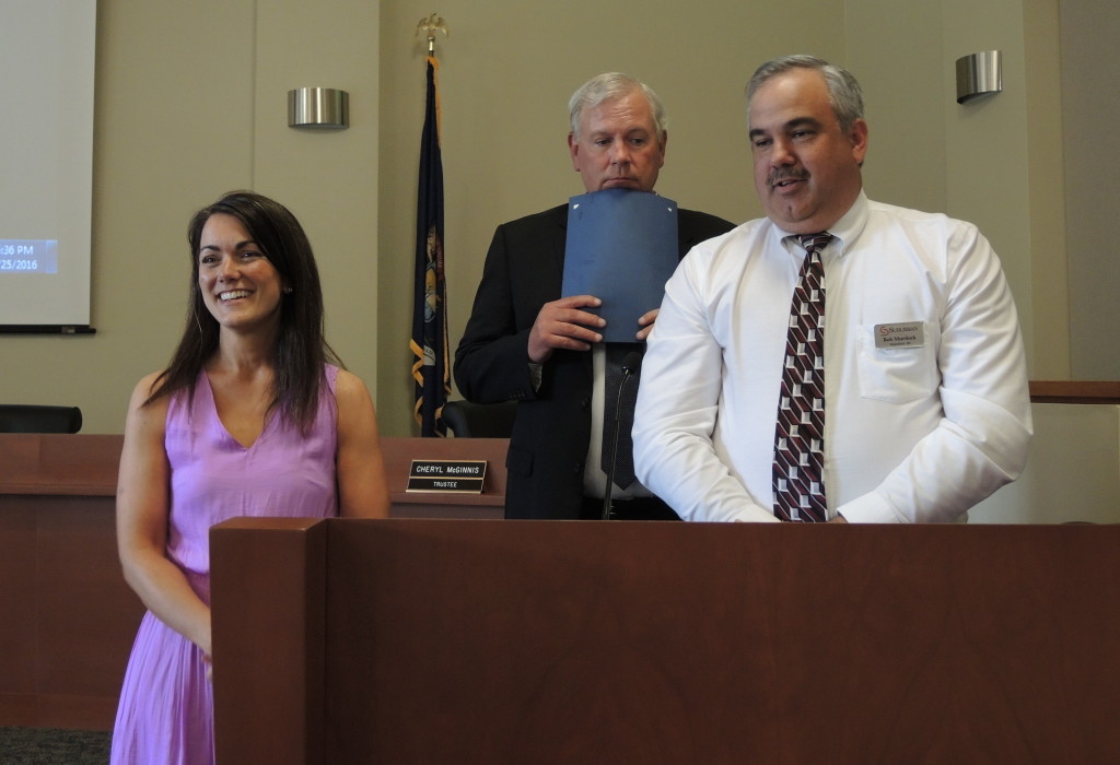 Bob Murdock of Suburban Ford, at right, and Mike Page of the Clarkston Foundation present the Teacher of the Year award to Meredith Copland. 