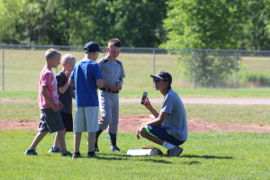 The boys check out their time during base-running and if they beat their coach. Photos by Wendi Reardon  