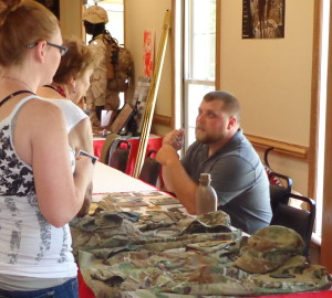 Josh Beal, who served with the First Infantry Division in combat from 2013-2014, talks to visitors about his service. 