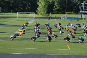 The varsity players warm up at 8 a.m. to get the season going.  Photo by Wendi Reardon