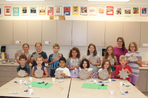 Kids in the morning session of Ceramic Camp display the sunshine they created out of clay. Back row from left, Lillian Stephenson, Addison Newblatt, Alex Kolean, Audrey Willis, Abby Robinson, Annika Griffin, teacher Amy Orahood, Lauren Butcher; front row, Nathan Cairns, Charlie Swick, Percival Valascho, Meredith Rainoldi, Kaitlin Woodward and Max Olson. Not pictured, Nolan Payne. Photosby Wendi Reardon