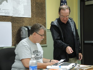 Rich Little, at right,  helps out with paperwork at the Oct. 3 Clarkston Planning Commission meeting, with Commission member Mike Sabol. Photo by Phil Custodio