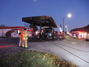 Independence Township fire fighters oversee clean up after the fire at Citgo last Thursday. Photo by Phil Custodio