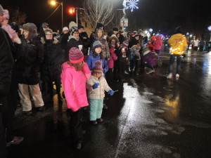 It was too dark for marchers to throw candy, so they handed them out to kids instead.