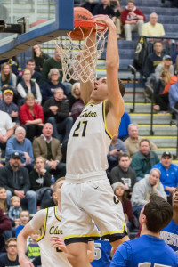 Dylan Alderson dunks a basket during the Wolves’ win over Walled Lake Western. Photo by Larry Wright