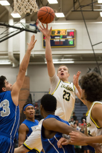 Taylor Currie shoots against Walled Lake Western in the second quarter.  Photo by Larry Wright