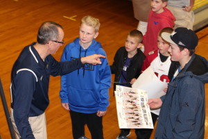 Dan Fife gives tips to youngsters as he signs their posters after the game, March 3. Photo by Wendi Reardon Price