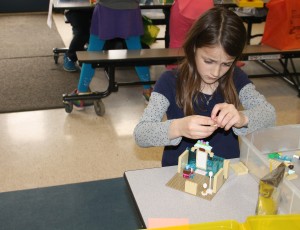 Third grader Lucy Fabrizio building in the lego competition