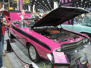 Clarkston owner Denise Myers' 1971 Challenger Convertible, panther pink with black leather interior, sits in the Cars of Mopar Women display. 