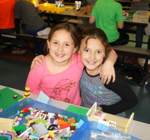(from left) second graders Emma Carter and Emma Redman posing for a picture with their lego projects