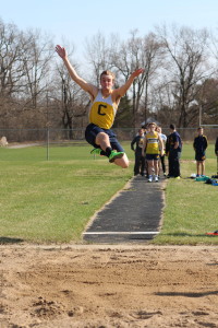 Junior Josh Kelley leaps during one of his tries in the long jump in Clarkston's win  against Rochester Adams last week at home. Photo by Wendi Reardon Price