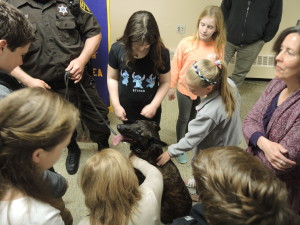 The students get a chance to pet Diago, a K9 police dog. He was at the Optimist Club meeting with his partner, Deputy Rodney White. Photo by Phil Custodio