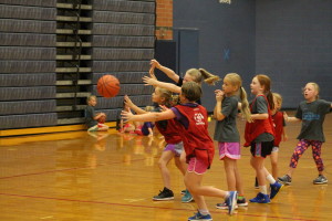 Young campers go after the ball in a game of basketball last Thursday during Dare to Dream. Photo by Wendi Reardon Price