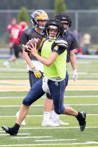 Jakob Jensen runs with the ball during a play at last Thursday's scrimmage. Photo by Larry Wright