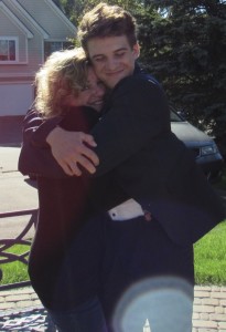 Jake Billette gives his mother, Linda, a big hug. He will play for her during Football for a Cure, Sept. 8. Photo provided