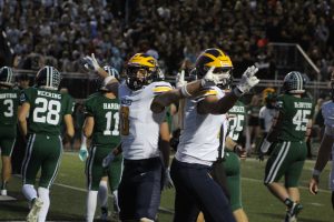 Junior Griffin Boman and junior Hayden Flavin celebrate Boman’s 1-yard touchdown run in the first quarter. Photo: Wendi Reardon Price